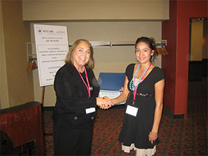 Denise Loveland of Horizon Management Group and Board Member of WI-CARH, (at left) presents Misty Curleyhair