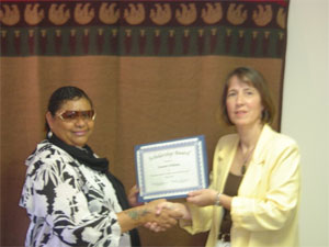 Mary Vinopal of Impact Seven, Inc. and President of WI-CARH, (at right) presents Susanne Williams